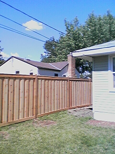 Cedar framed batten board privacy fence installation St. Louis Park, Minnesota