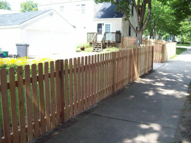 Cedar dog eared picket fence installation Minneapolis, Minnesota