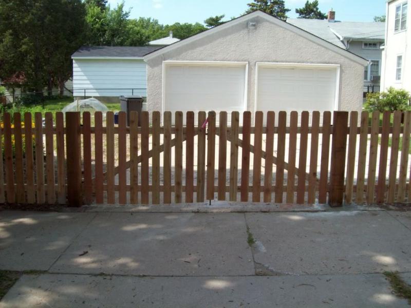 Cedar dog eared picket fence installation Minneapolis, Minnesota