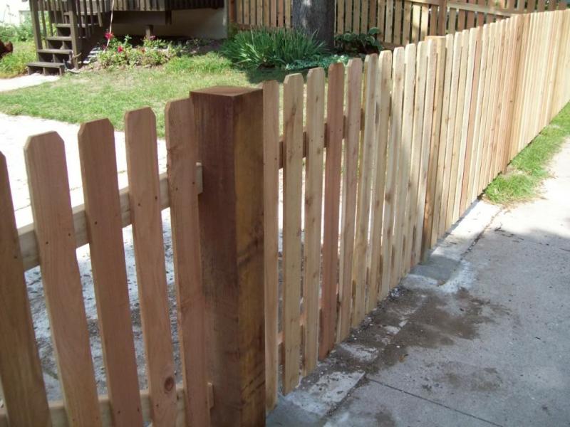 Cedar dog eared picket fence installation Minneapolis, Minnesota