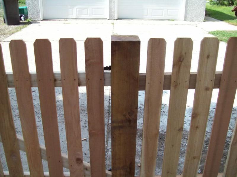 Cedar dog eared picket fence installation Minneapolis, Minnesota