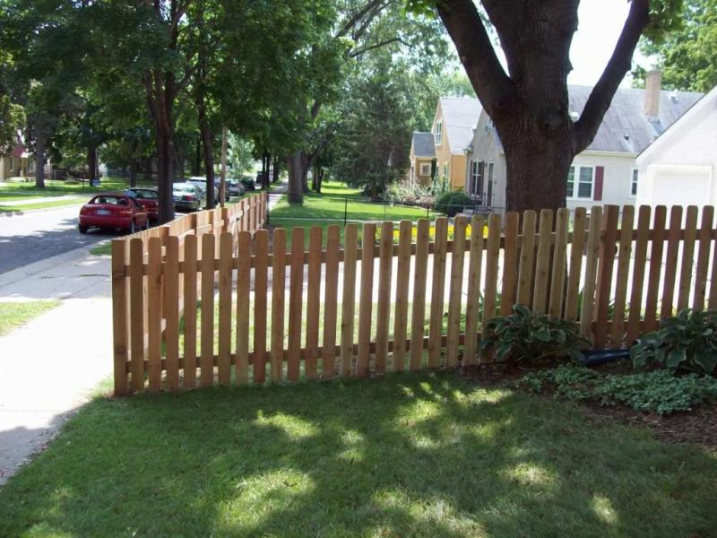 Cedar dog eared picket fence installation Minneapolis, Minnesota