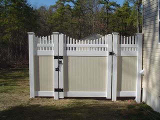 Installation of two-tone vinyl privacy fence Minneapolis, Minnesota