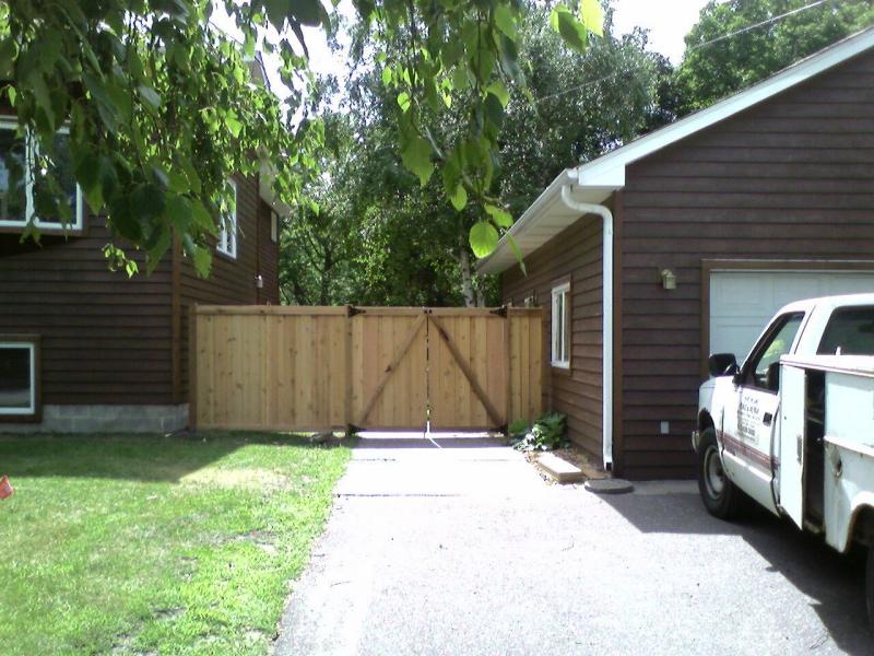 Cedar framed batten board privacy fence installation Robbinsdale, Minnesota