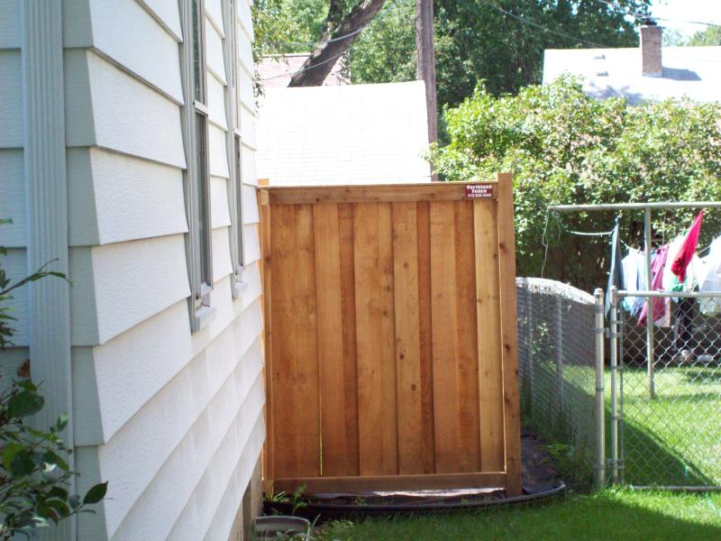 Cedar framed batten board privacy fence installation Minneapolis, Minnesota