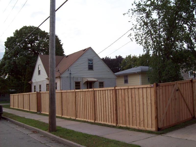 Cedar framed batten board privacy fence installation Minneapolis, Minnesota