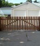 Cedar dog eared picket fence installation Minneapolis, Minnesota