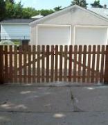 Cedar dog eared picket fence installation Minneapolis, Minnesota